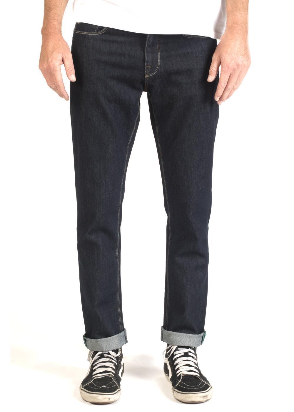 Front view of Vissla Profile Denim 5 Pkt Pant in dark wash with cuffed hem.