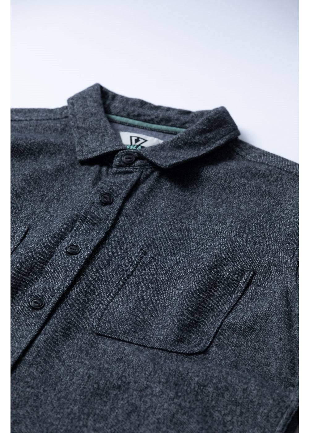 Close-up of Vissla Shaper Eco Flannel chest pockets and collar in black.