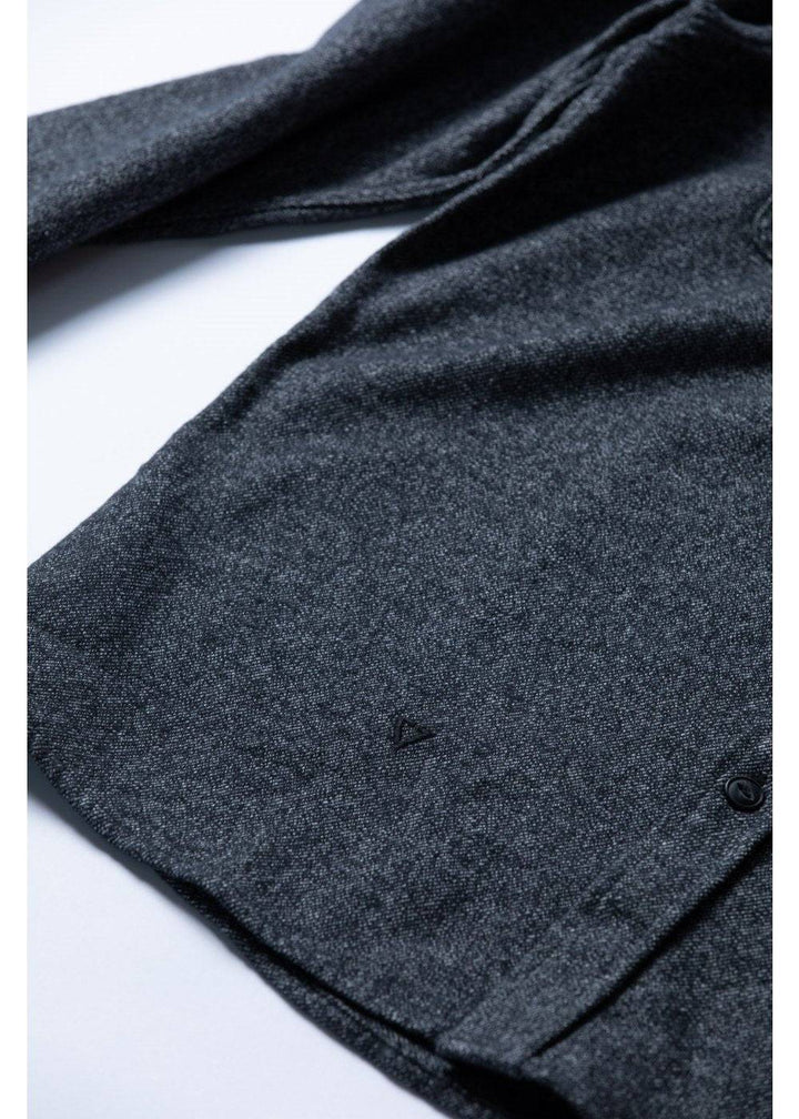 Close-up of Vissla Shaper Eco Flannel fabric and hem details in black.