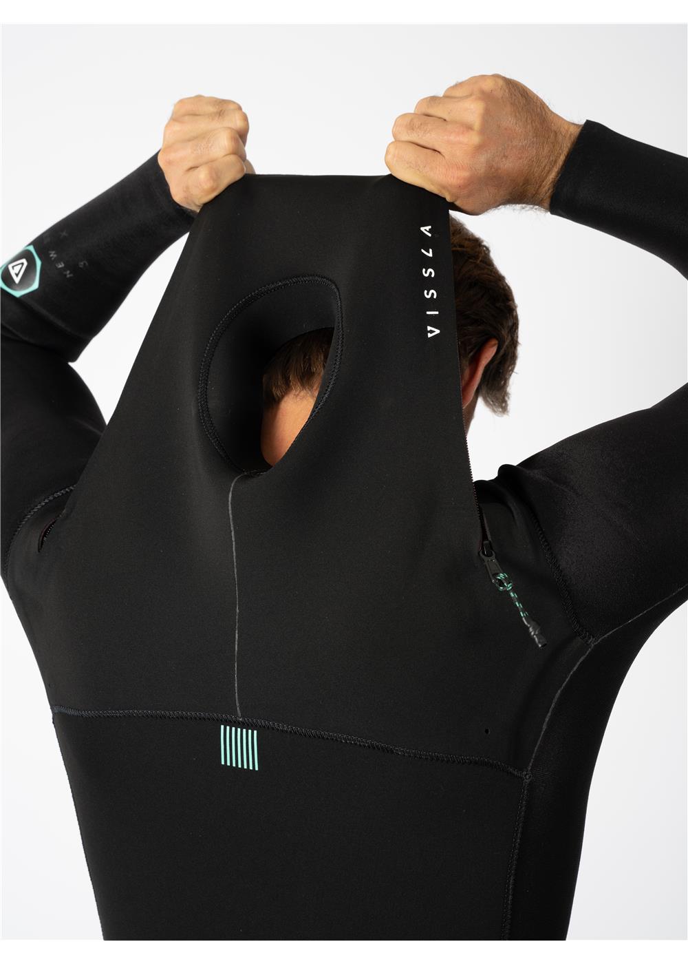 Person putting on Vissla wetsuit hood, showcasing flexibility and fit.